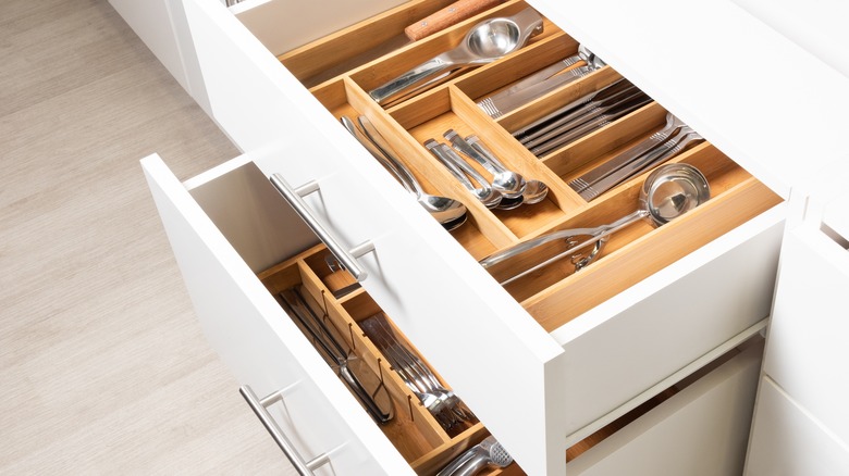 An open draw holds organized utensils