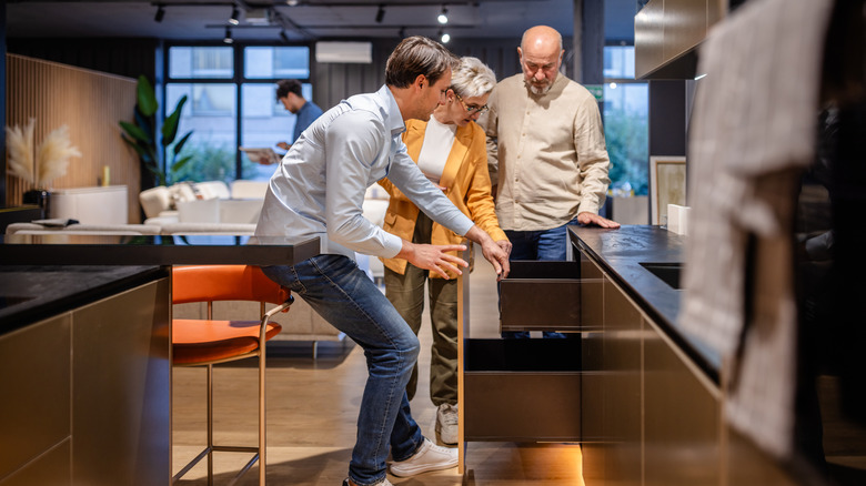 People looking through a kitchen showroom