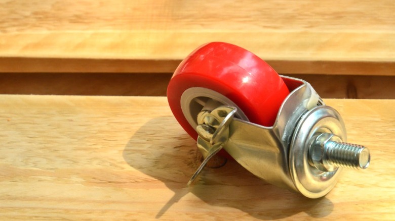 red caster wheels on finished wood boards