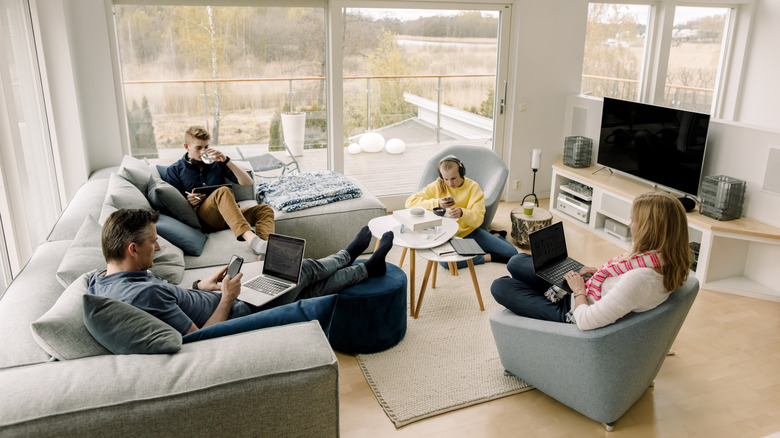 family sitting in the living on different seating