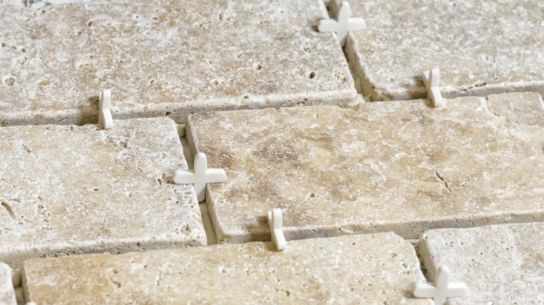 limestone tiles set in floor with spacers between them