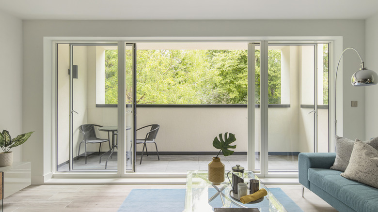 Sliding glass doors opening up to a balcony from a living room