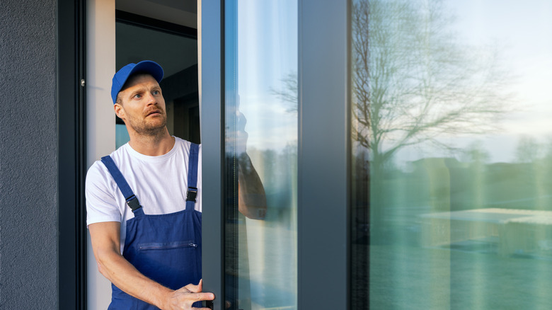 A man standing in an open sliding doorway