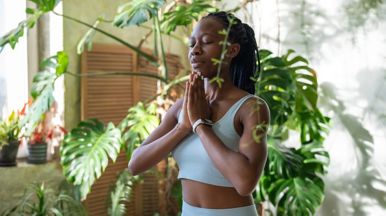 woman meditating in garden