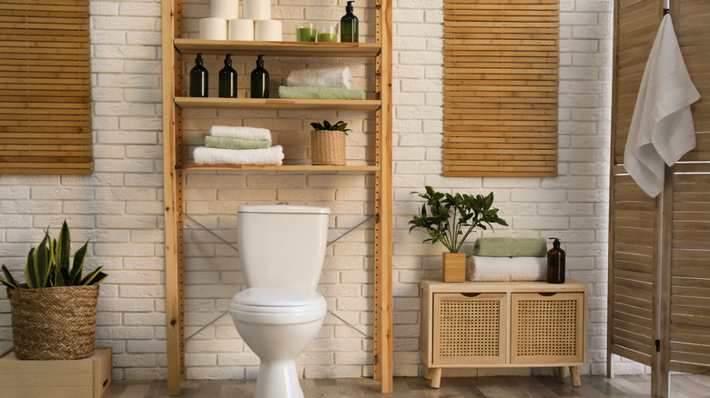 Toilet in stylish bathroom with a large over-the-toilet shelves