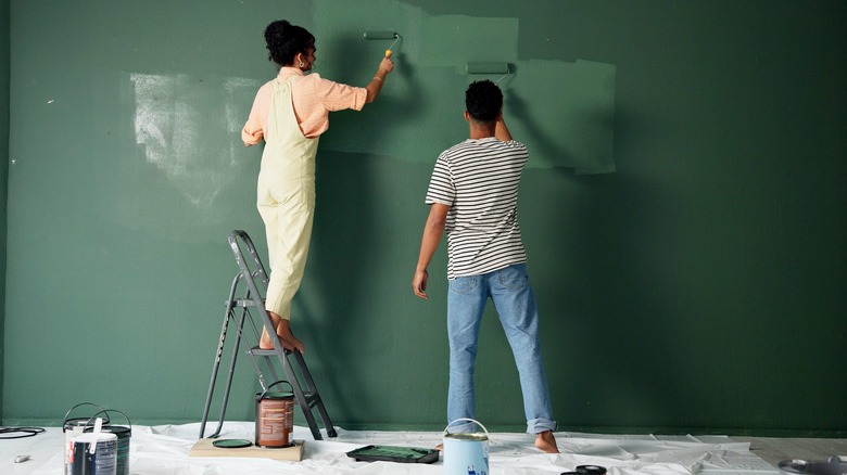 couple painting wall