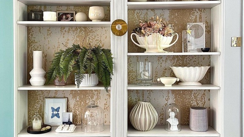 Bookcase with gold wallpaper