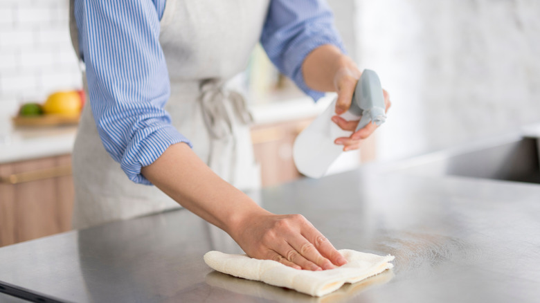 Woman wiping her kitchen countertops