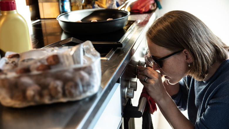 Woman interacting with oven