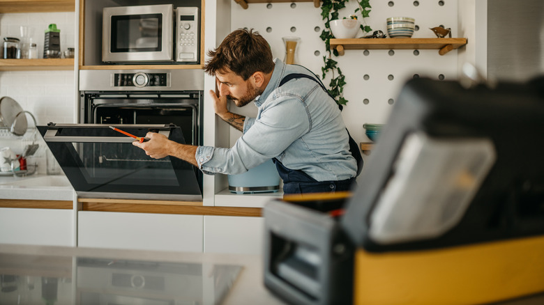 Professional inspecting an oven