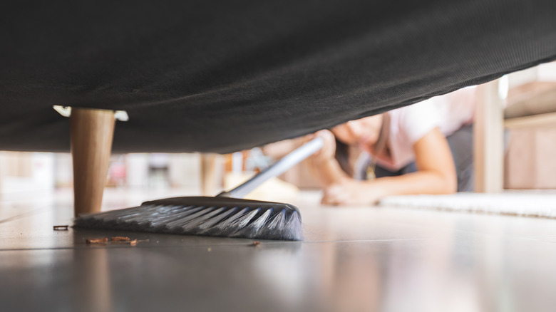 sweeping under furniture