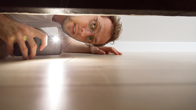 Man checking under the bed