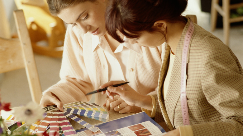 Two people looking over different color swatches