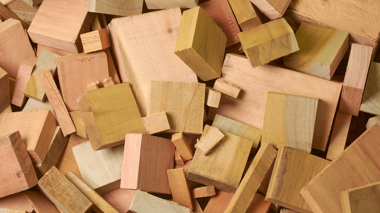 Piles of scrap wooden blocks and planks are bundled together