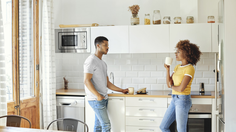 couple in kitchen drinking coffee
