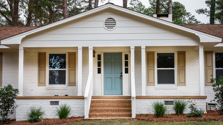 white ranch home with landscaping