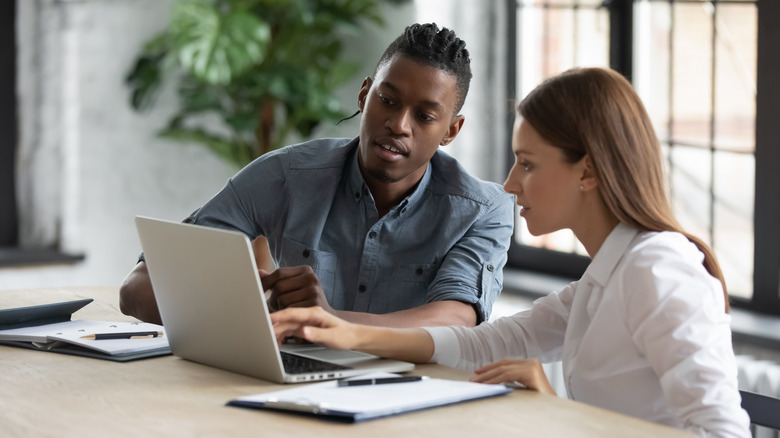 two people looking at laptop