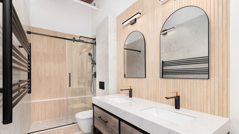 A bathroom with wood accent wall