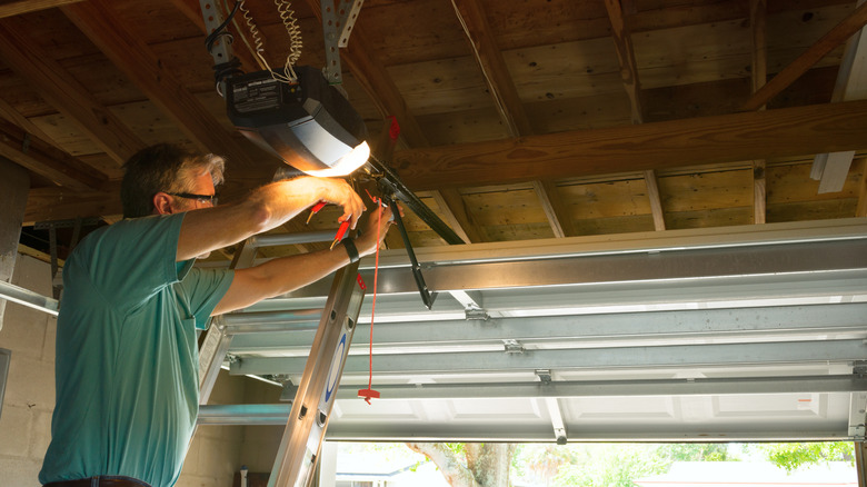 A man fixing a garage door opened