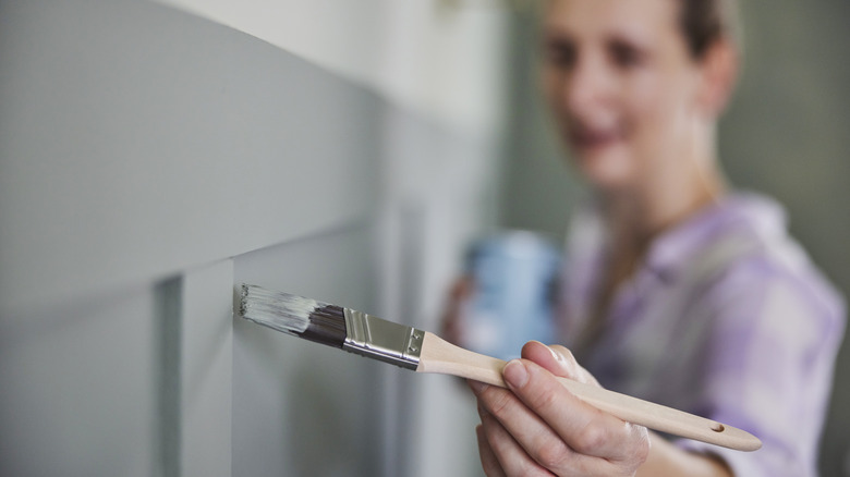 woman painting paneling