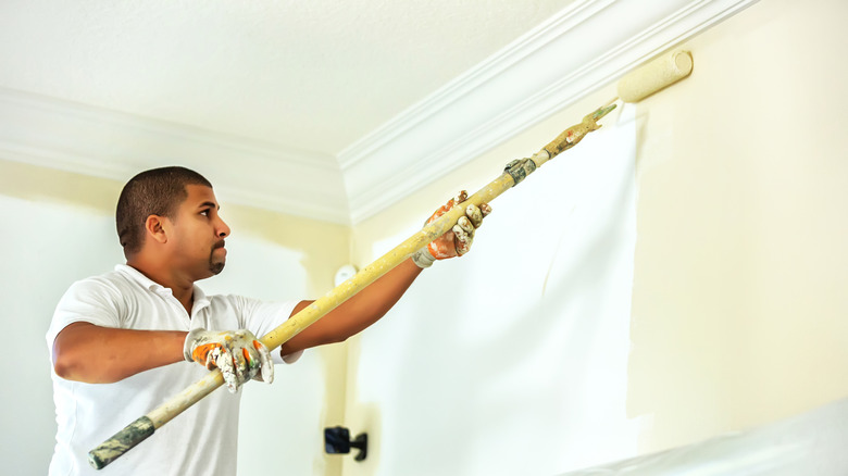 man painting high ceiling