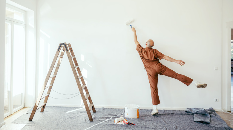 Person painting wall