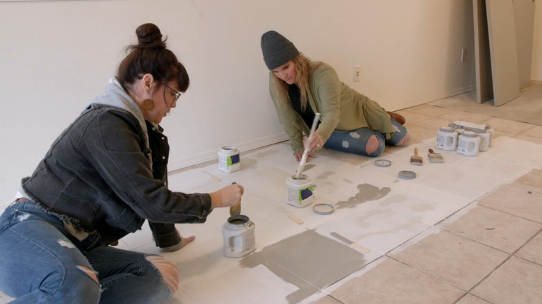 sisters painting floor tiles