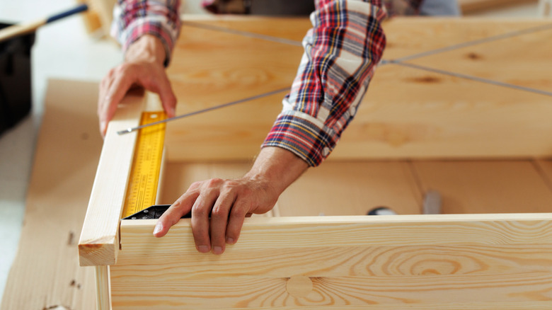 A man building a bookcase