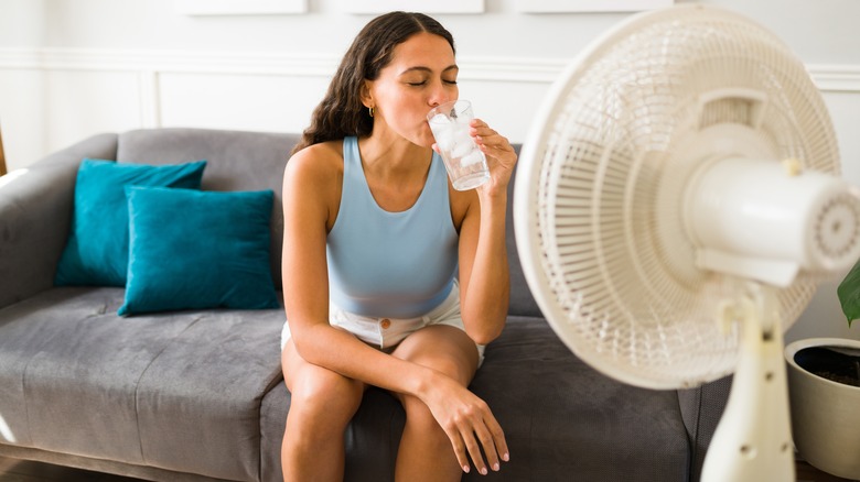 woman sitting in front of fan