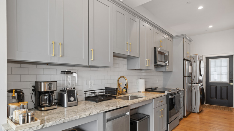 Gray cabinets with gold fixtures