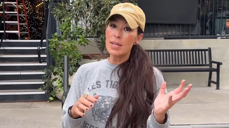 Joanna Gaines gestures in front of Magnolia shop