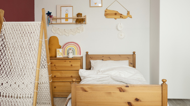 A children's bedroom features a solid wood bed.