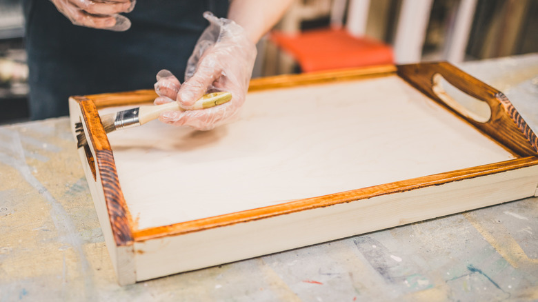 carpenter working on wooden tray