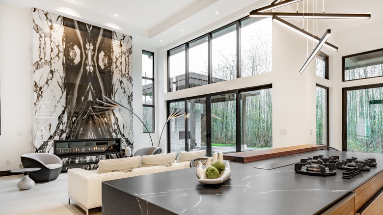 Contemporary room with floor-to-ceiling windows and marble fire surround