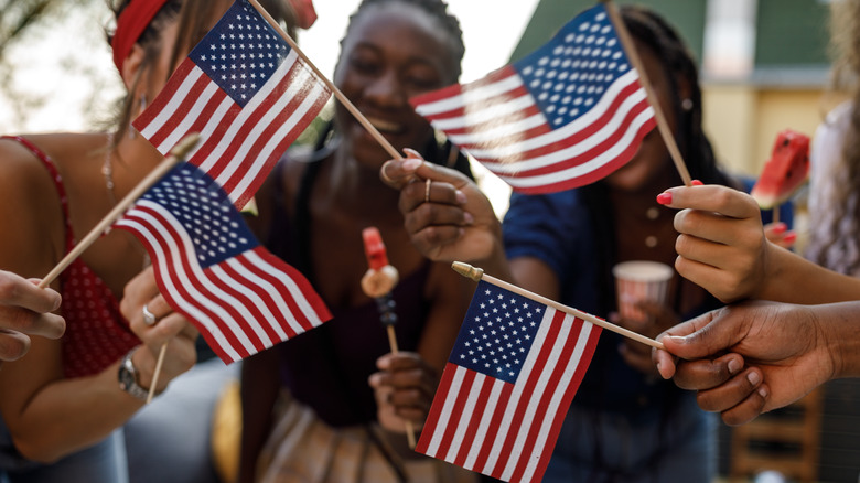 Friends holding American flags