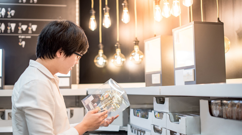 man shopping for light bulbs