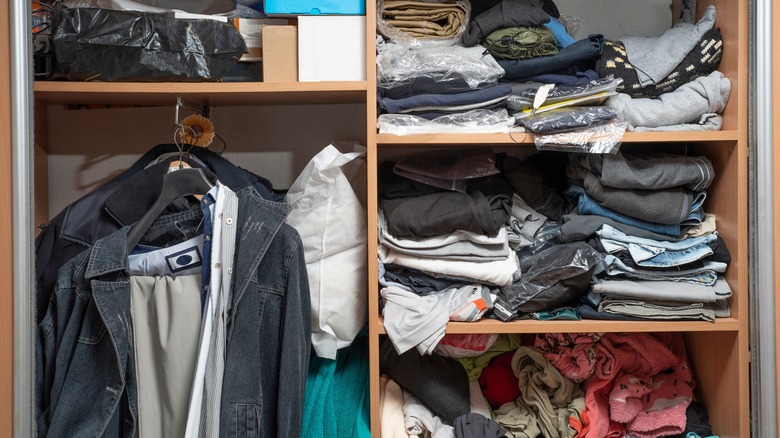 messy clothes closet with coats