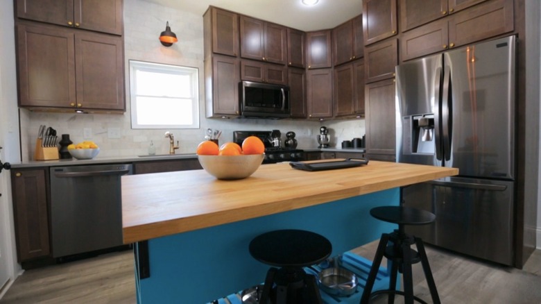 dark kitchen with blue island 