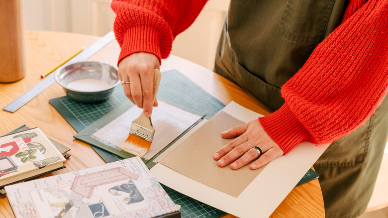 Person painting on handmade glue