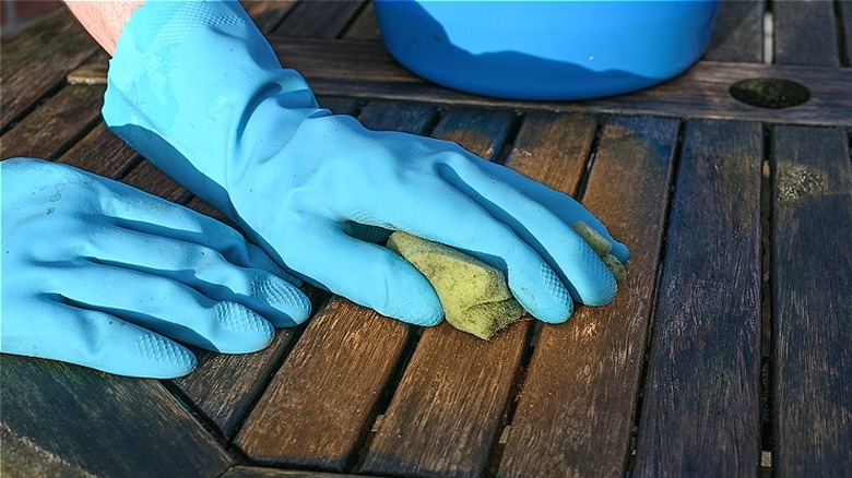 Person cleaning wood furniture