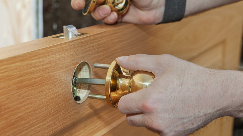 Changing out a doorknob to a brass one