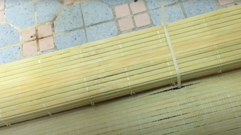 A bamboo mat rolled up and secured with a cable tie