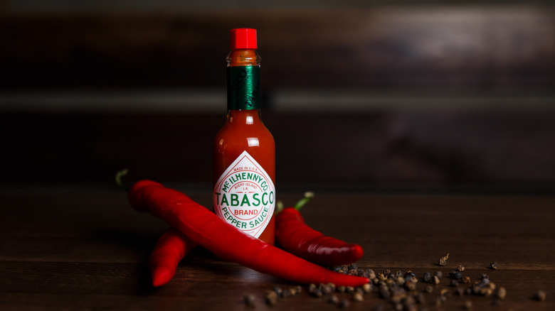 Tabasco surrounded by peppers and hot chili