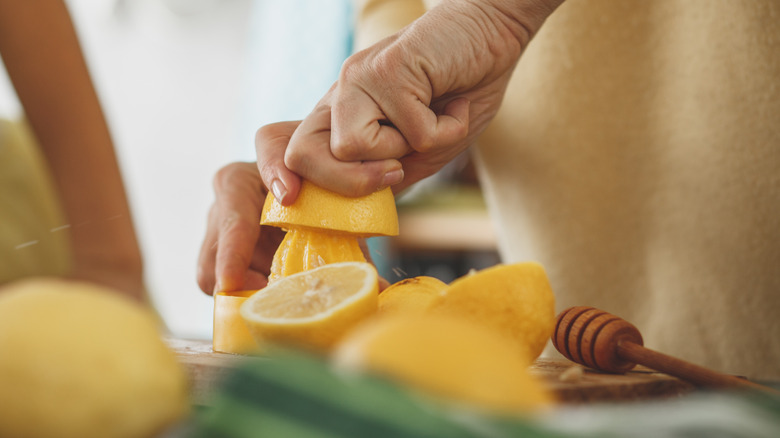 woman slicing and juicing lemons