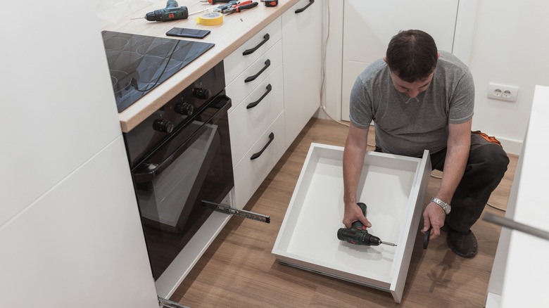 man fixing a kitchen drawer