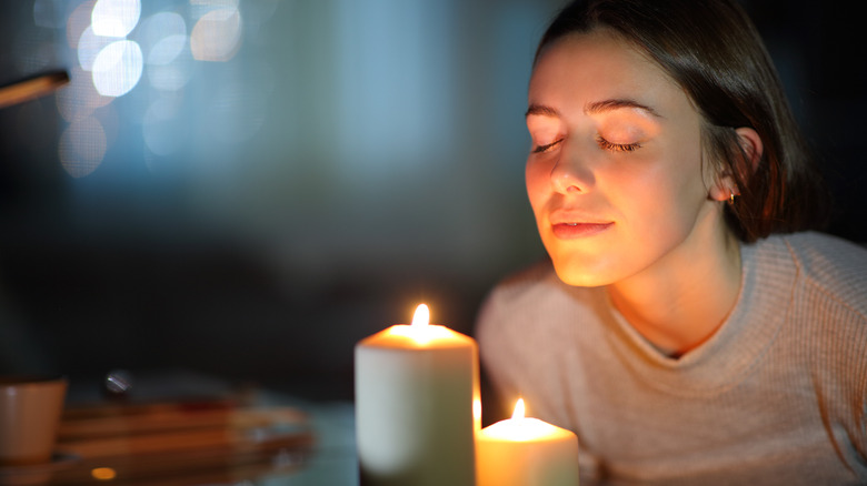 Woman smelling candle