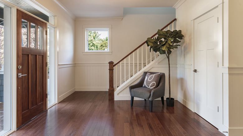 Open foyer with a chair and a plant