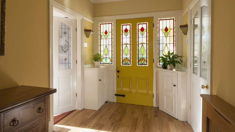 Sunny yellow foyer with stained glass door