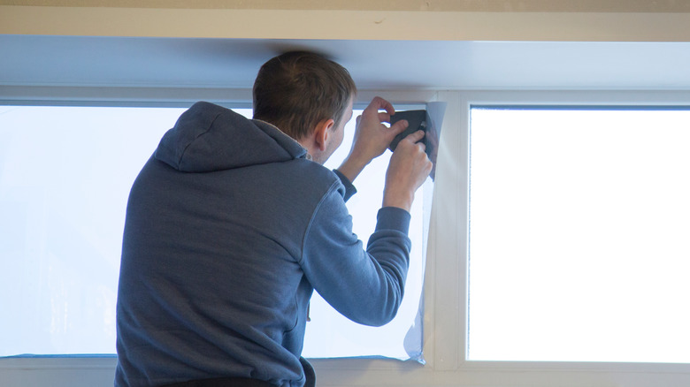 Man applying window film