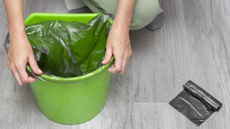 woman replacing trash bag